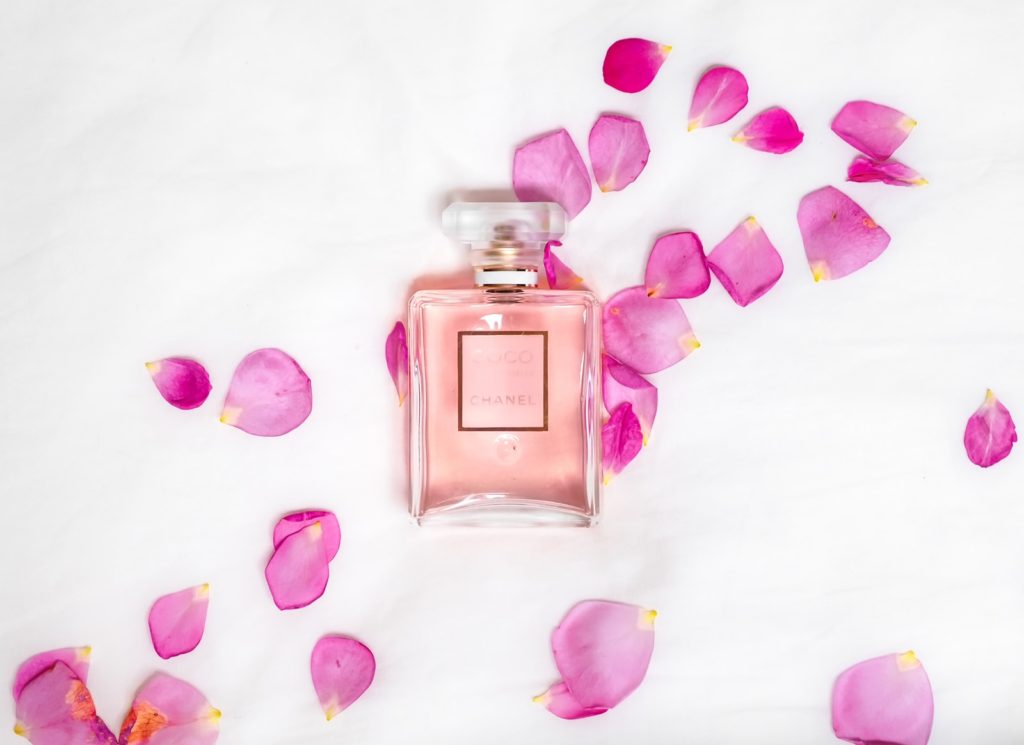 perfume bottle with pink petals