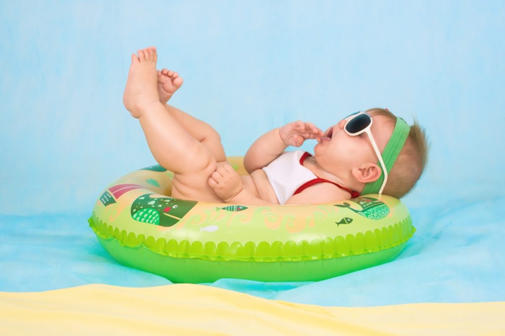 baby lying on inflatable ring.  Being a babysitter to your caregivers creates a toxic work environment